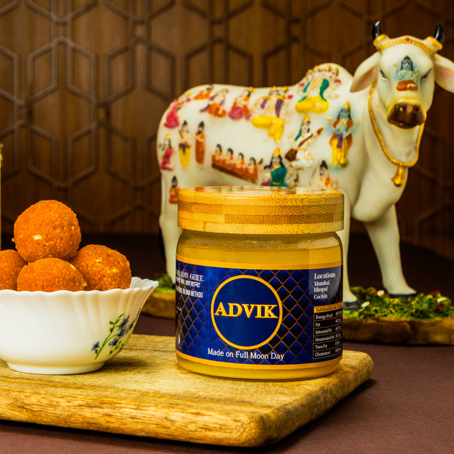 Advik A2 Gir Cow Ghee – 500ml jar of pure desi ghee made from the milk of Gir cows at Periyar Gaushala, crafted using the traditional Vedic Bilona method with a red sandalwood churner, slow-cooked over a cow dung fire, and produced exclusively on full moon days to enhance its nutritional and spiritual qualities