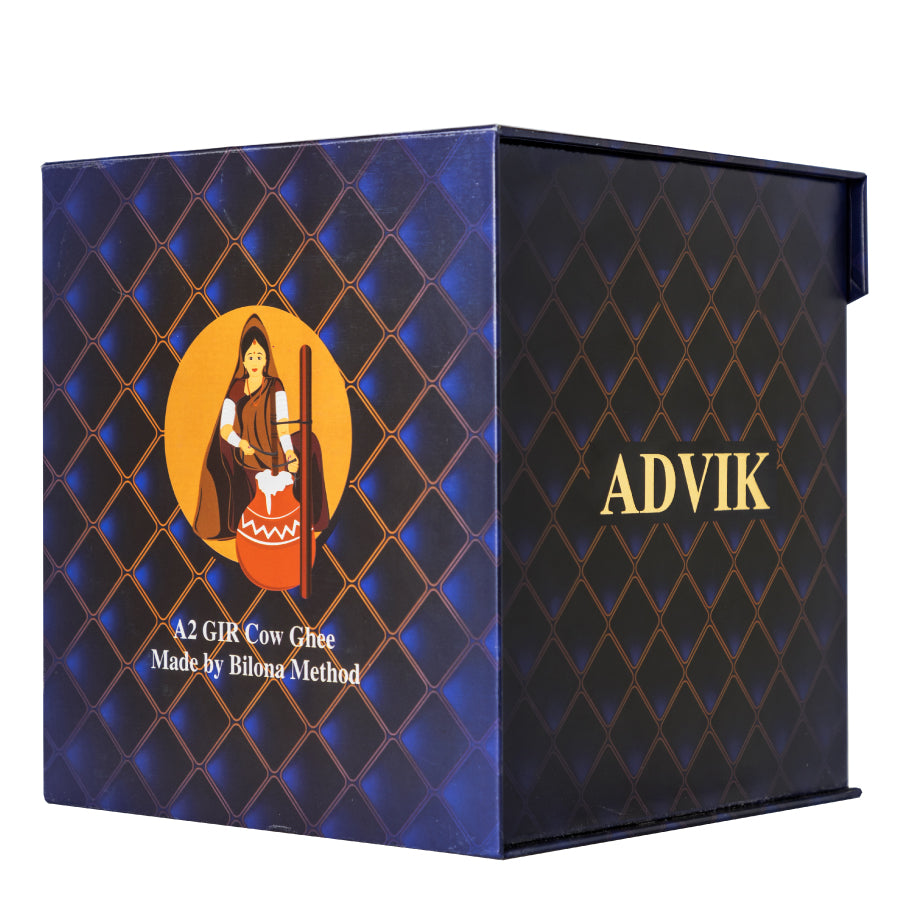 Advik A2 Gir Cow Ghee – 500ml jar of pure desi ghee made from the milk of Gir cows at Periyar Gaushala, crafted using the traditional Vedic Bilona method with a red sandalwood churner, slow-cooked over a cow dung fire, and produced exclusively on full moon days to enhance its nutritional and spiritual qualities